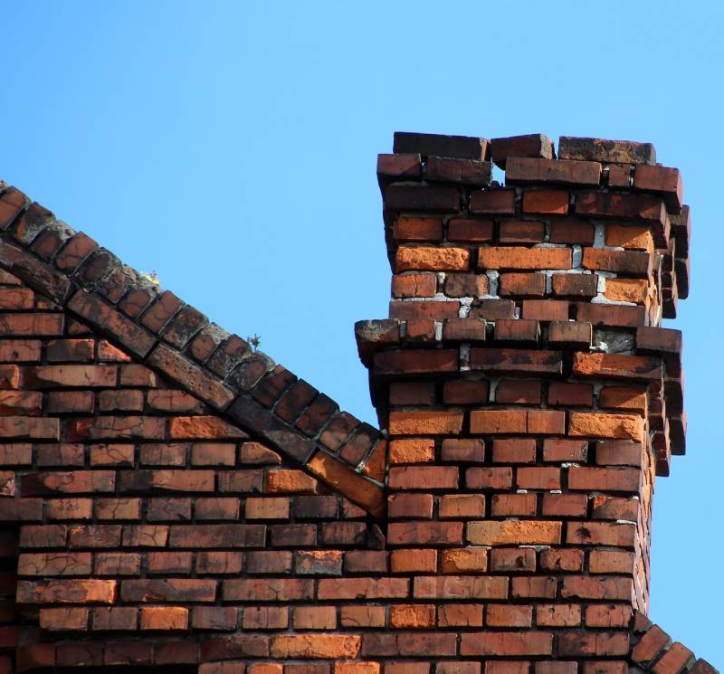 Signs Your Pembroke Home Needs a Chimney Inspection Damaged chimney on an Pembroke home showing cracks and missing mortar